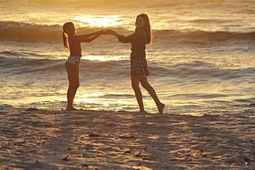 playing girls on the beach