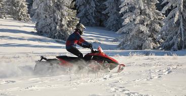 man driving on snowmobile in Winter