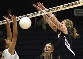 Girls, playing volleyball on the competition