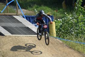 young boy Jumps with Mountain Bike