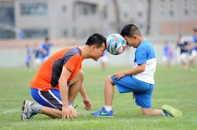 action photo of competing football players of different generations