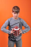 teen boy holds ball, Portrait