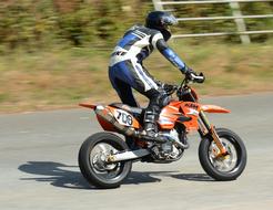 athlete standing drives a motorcycle