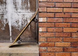 Skateboard near a brick wall