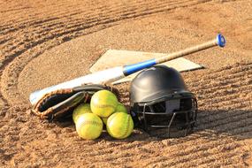 Colorful equipment for softball, on the sand