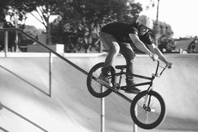 young boy doing Bike Stunt, black and white