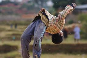 ragged Boy doing Somersault outdoor