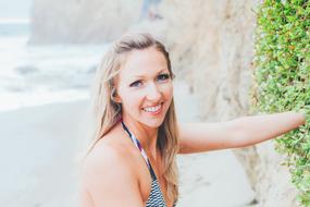 beautiful girl in bikini near the wall on a blurred background