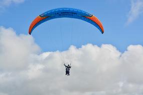 tandem Paragliding, happy people at clouds