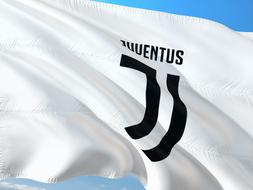 white flag of juventus team at sky