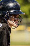 photo of a young baseball player in a black helmet