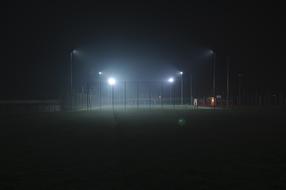 Beautiful, grass sports field in the light of spotlights