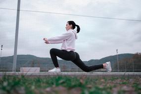 girl is doing gymnastics outdoors