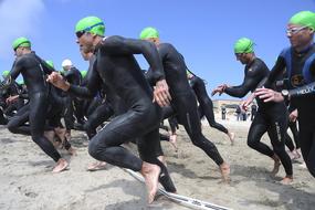 Athletes on the sandy beach, on the triathlon race
