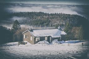 wooden hut in the winter mountains