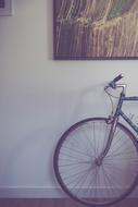vintage bicycle near the wall with a picture