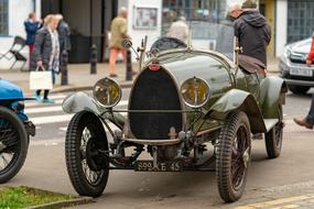 Beautiful, old, vintage Bugatti car, on the street, near the people