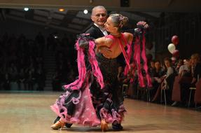 Dancers in the beautiful, black, pink and white costumes, dancing in the living room