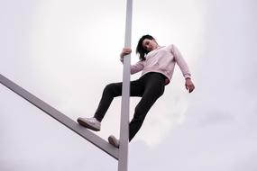 Girl, posing on the metal construction