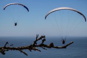 two paragliders above sea