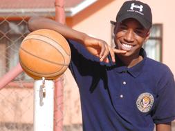 young basketball player with a ball on a sunny day