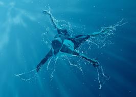 young man dance in water