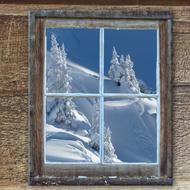 view from the window of the old hut to the winter mountains