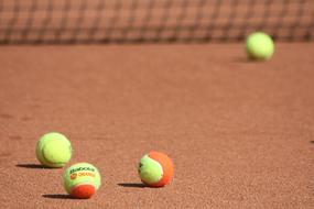 green orange tennis balls on the court