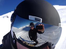 Person, taking photo of a person, with the helmet and goggles, with the reflection