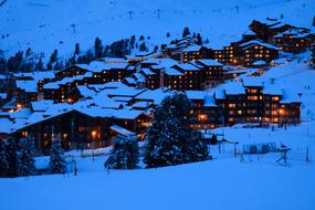 village in snowy alps in the evening
