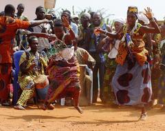 Voodoo people in colorful costumes, dancing in Benin, Africa