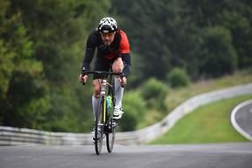 man rides a bicycle on a race track