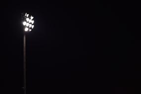 Bright stadium lights at black background