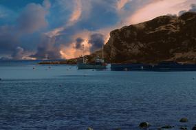 fishing ship by the rocky seashore