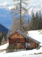 wooden cabin in the alpine mountains in winter