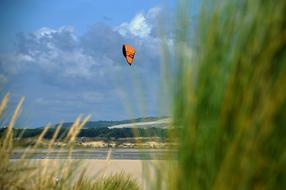 Person, doing kitesurfing, above the water in the Touquet, Hauts De France, France