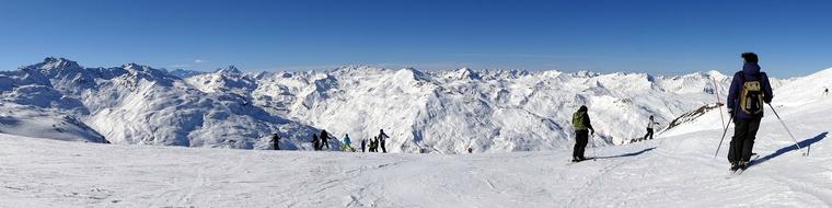 skiers in the alps on a sunny day