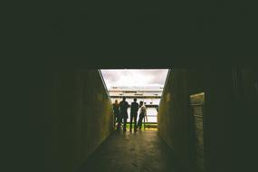 people stand in the tunnel of a football stadium