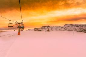 ski lift in Italy on the background of golden sunset