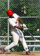 Baseball player, playing on the court with the fence