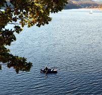 man in rowing boat on lake at autumn, germany, Rurtalsperre