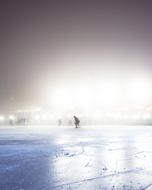 photo of a man ice skating on an ice arena