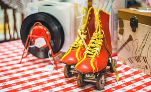 Vintage red and yellow roller- skates and records