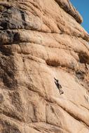 Mountain climber on the beautiful mountain in light, at blue sky on background