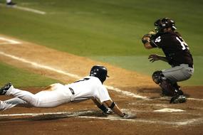 Players in uniform, playing baseball, on the colorful field