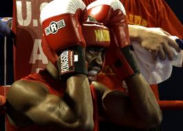 black boxer holds his head