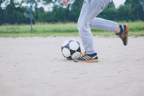 child's feet and soccer ball