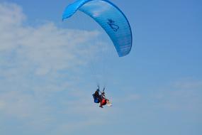 Paragliding sky blue white