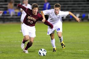 football teams fight for the ball on the field