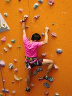 young boy Climbing wall, training